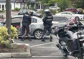 Motorcycle patrol officers arrest a warrant suspect in a Bellevue parking lot.