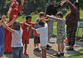 Actors and audience participate in outdoor theater.