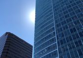 The sun peaks behind a building downtown.