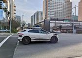 An automated vehicle is parked downtown.