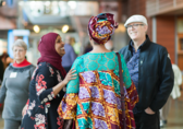 Attendees of a Cultural Conversations evening forum chat in the City Hall concourse.