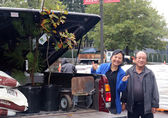 A Bellevue couple give a thumbs-up when they pick up a pair of trees in the 2022 giveaway.
