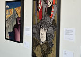 Two paintings in the AAHNPI exhibit hang on the second-floor concourses in City Hall.