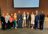Council members pose with affordable housing week proclamation.